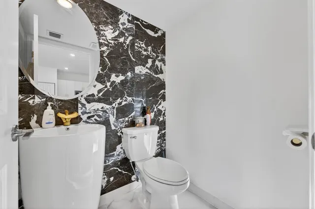 a living room with furniture a rug and a chandelier