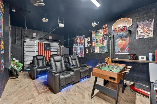 a bedroom with a bed and a flat tv screen on the dresser