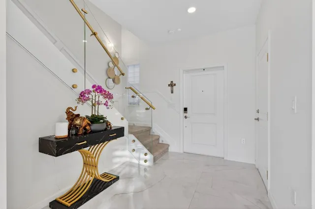 a kitchen with stainless steel appliances wooden cabinets a stove a sink a dining table and chairs