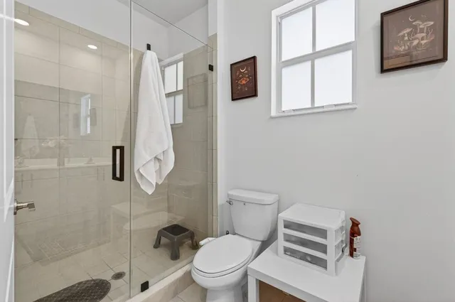 a front view of a house with potted plants