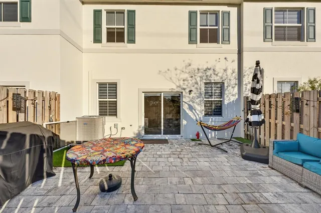 a roof deck with couches and wooden fence