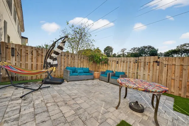 a room with lots of furniture and a floor to ceiling window