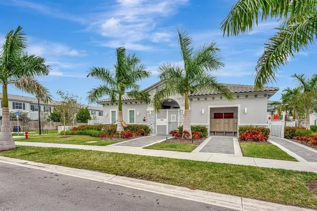 a view of a house with swimming pool and sitting area