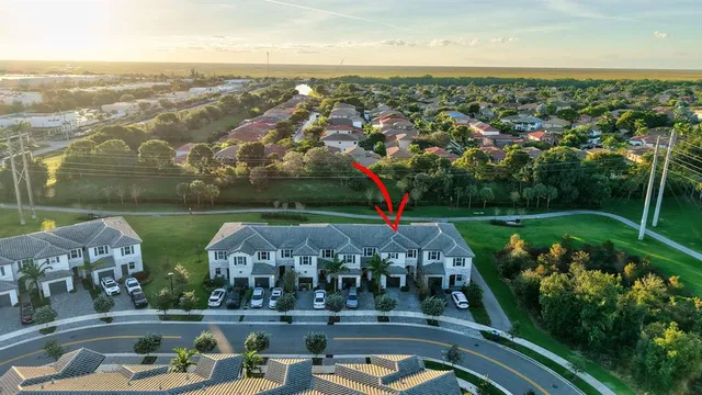 a front view of a house with plants