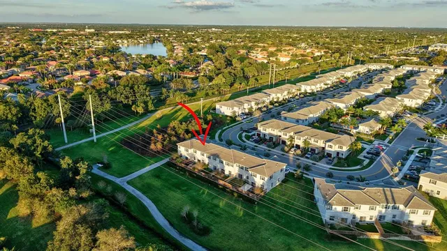 a view of a house with a yard and potted plants