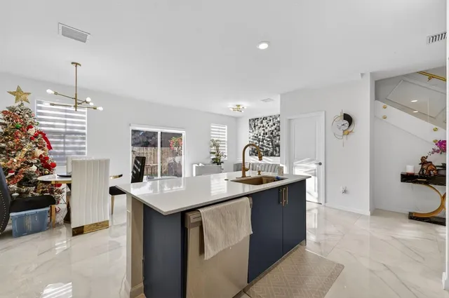 a kitchen with stainless steel appliances kitchen island granite countertop a sink and cabinets