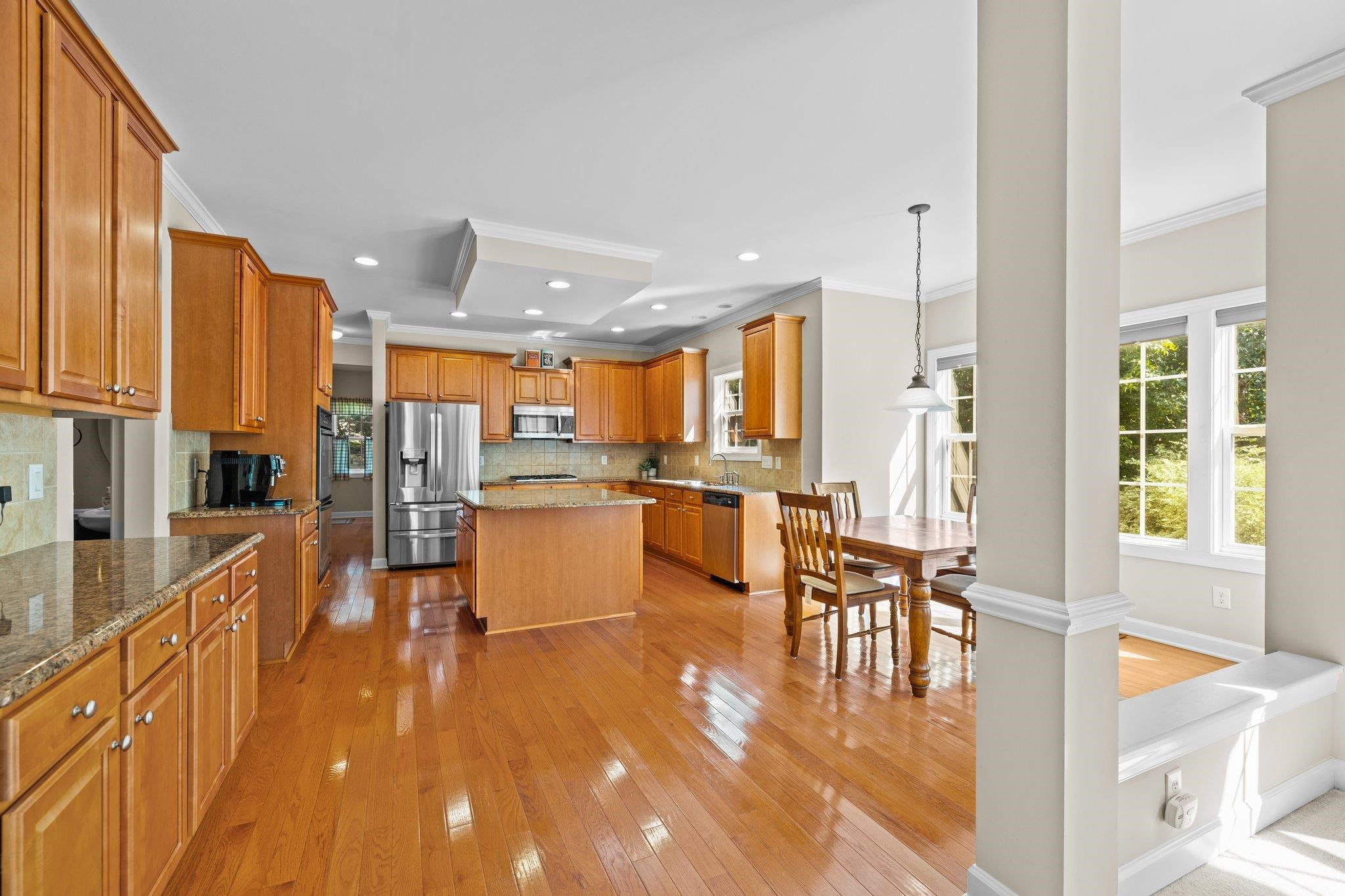 11900 Deneb Court Raleigh, NC 27614 - Photo 20 of 60 a dining hall with stainless steel appliances kitchen island granite countertop a refrigerator a stove and a sink with granite countertops