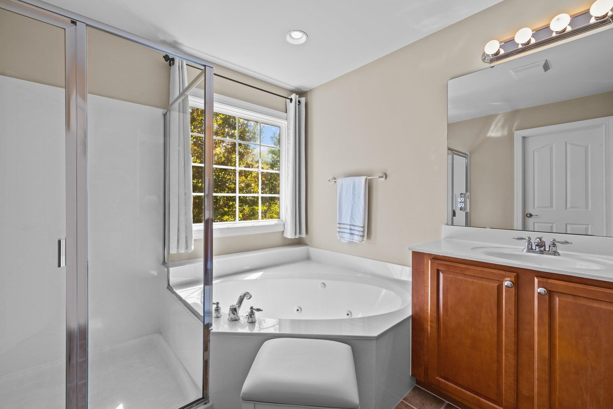 11900 Deneb Court Raleigh, NC 27614 - Photo 32 of 60 a bathroom with a granite countertop tub sink and mirror