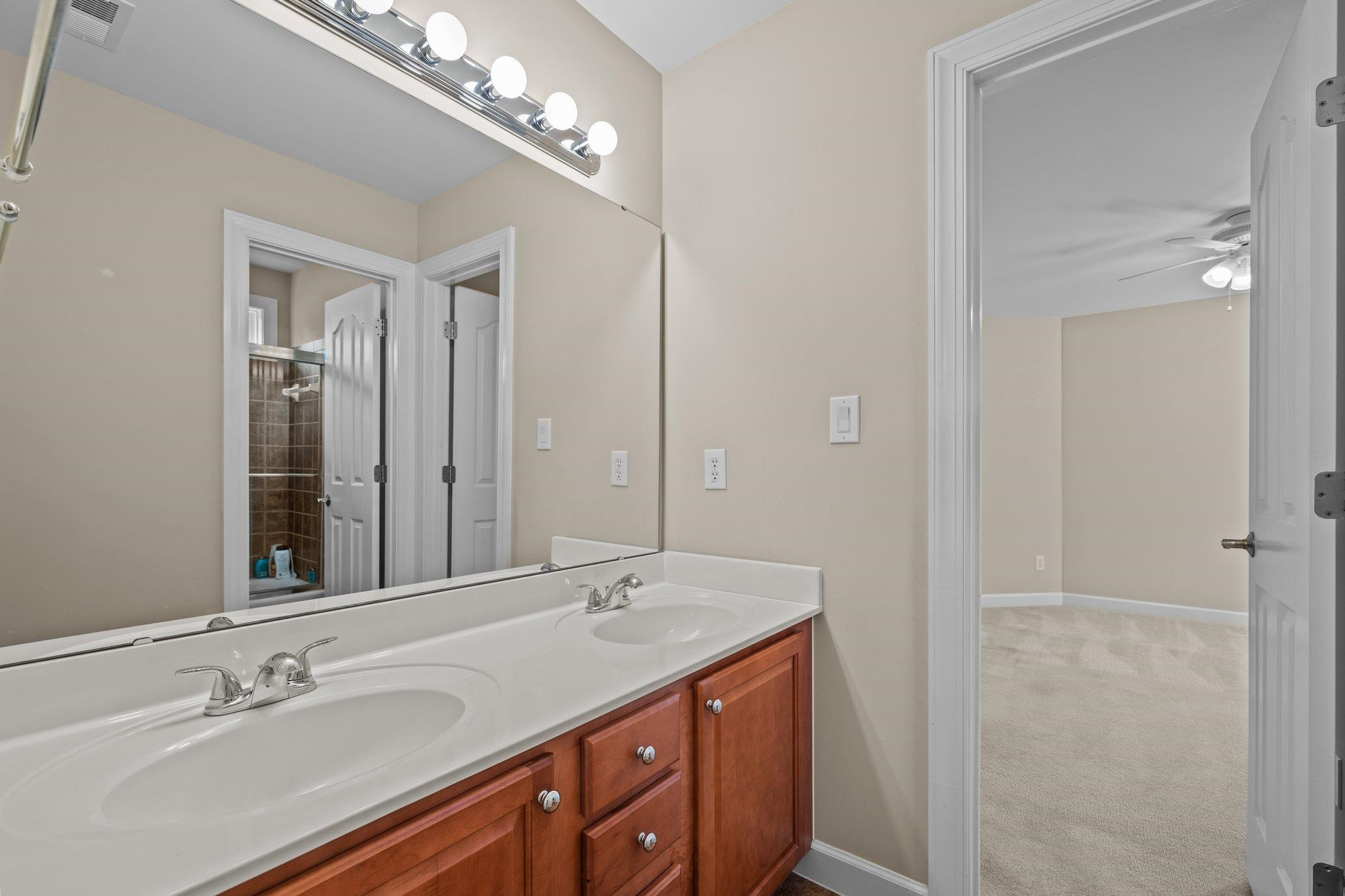 11900 Deneb Court Raleigh, NC 27614 - Photo 35 of 60 a bathroom with a double vanity sink and a mirror