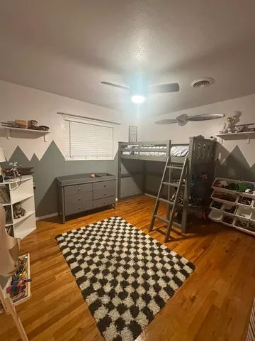 a bed room with a bed and a desk