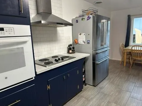 a kitchen with a stove and a refrigerator