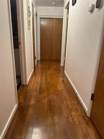 a view of hallway with wooden floor