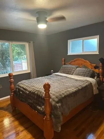 a bedroom with a bed and window