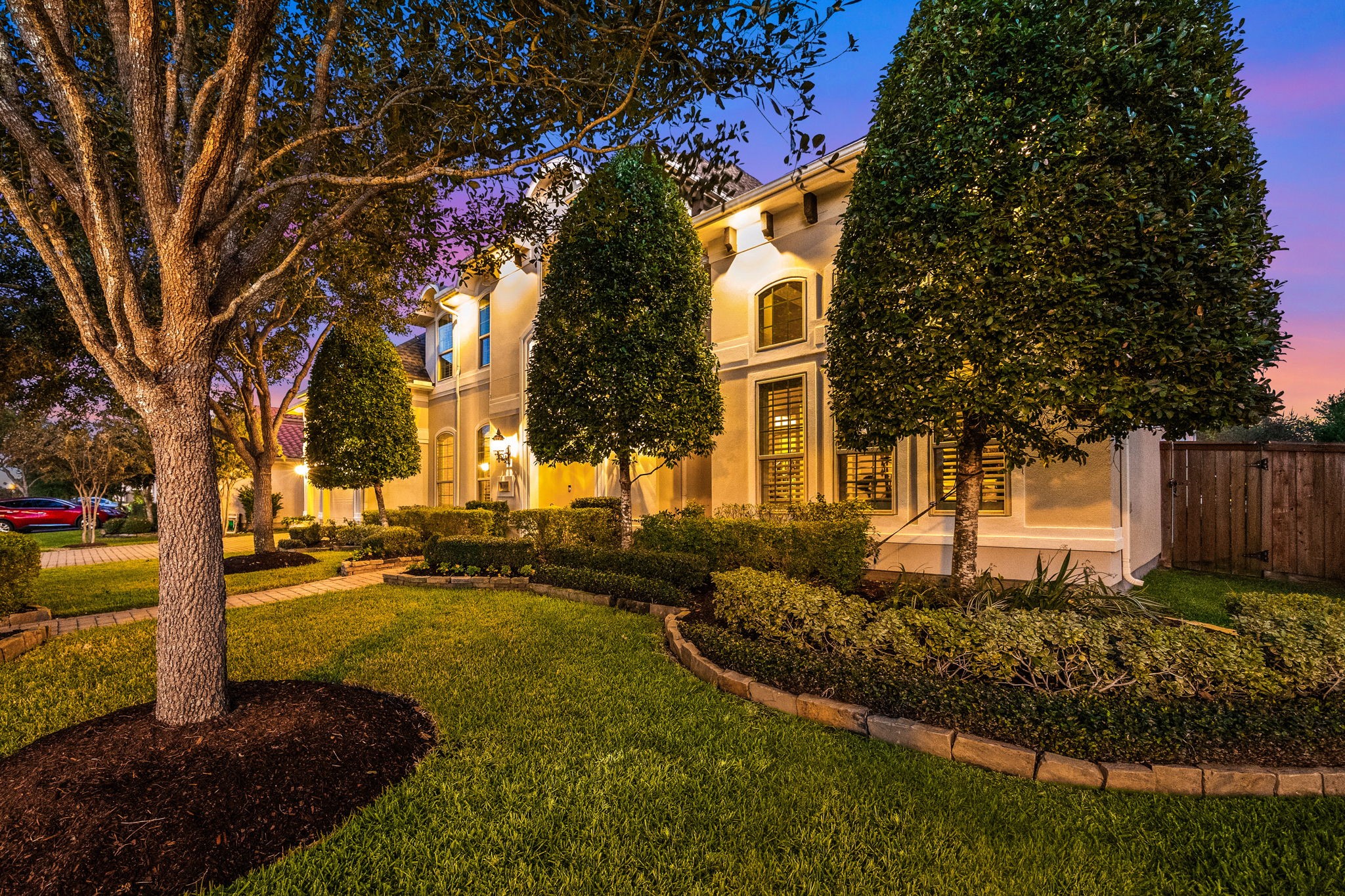 26515 Ashley Ridge Lane Katy, TX 77494 - Photo 4 of 50 Stunning landscape lighting and meticulously landscaped front yard featuring manicured bushes and mature trees.