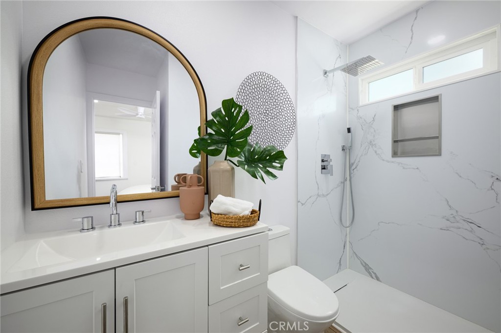 4705 East Washington Avenue Orange, CA 92869 - Photo 17 of 41 a bathroom with a sink a toilet and shower