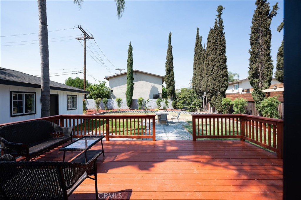 4705 East Washington Avenue Orange, CA 92869 - Photo 21 of 41 a view of a wooden deck with a bench