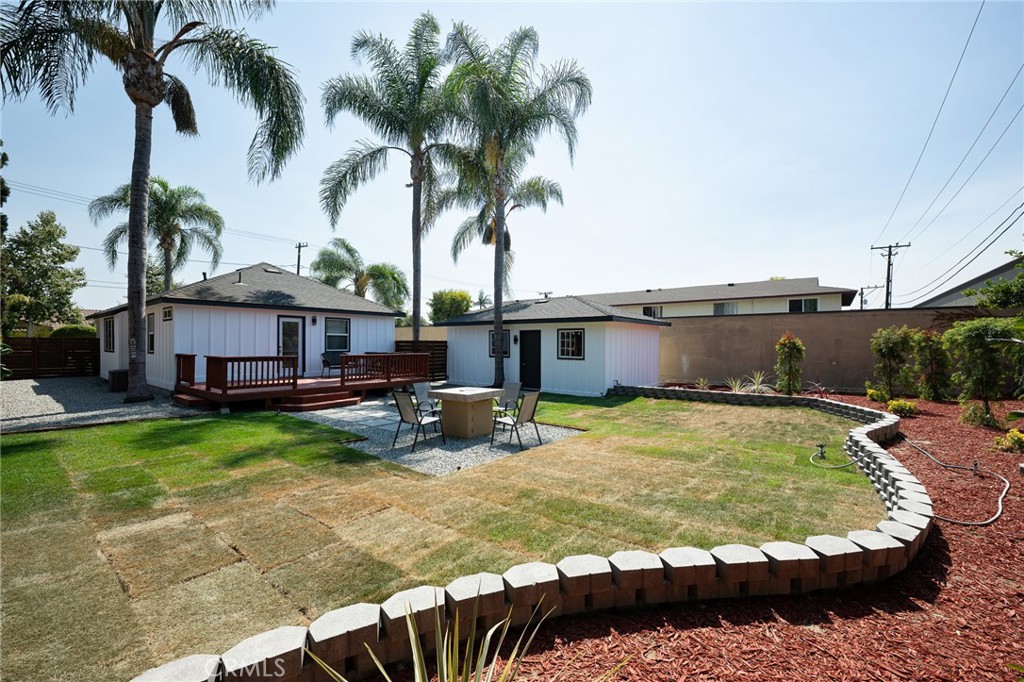 4705 East Washington Avenue Orange, CA 92869 - Photo 26 of 41 a view of a house with swimming pool and a yard