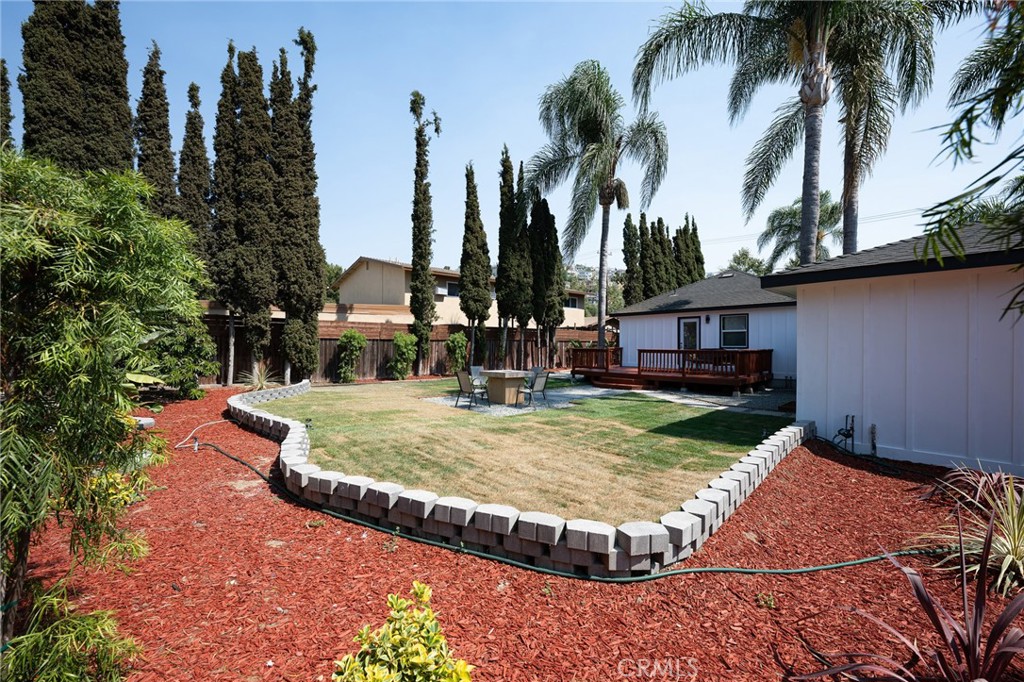 4705 East Washington Avenue Orange, CA 92869 - Photo 29 of 41 a swimming pool with outdoor seating yard and trees