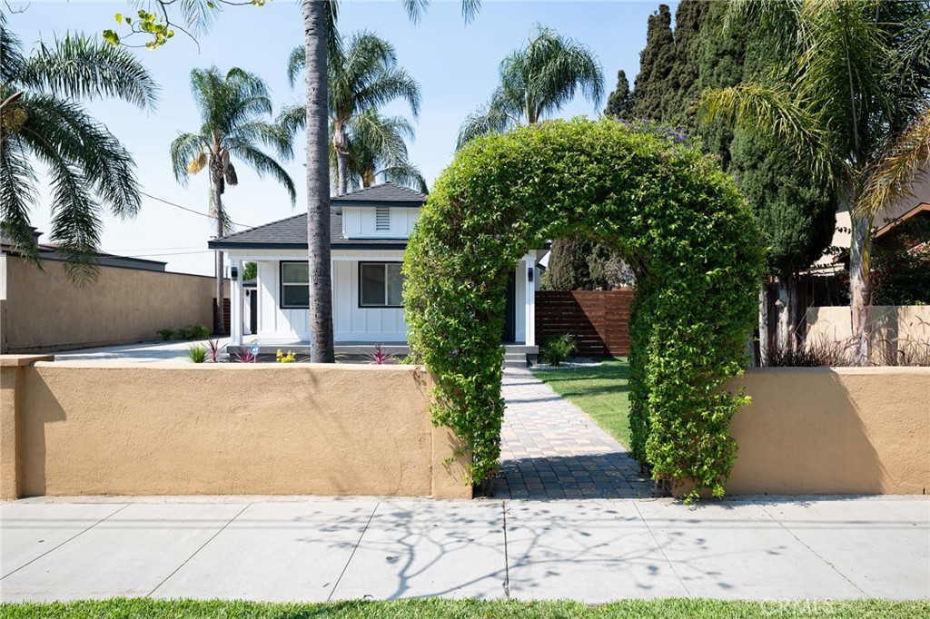 4705 East Washington Avenue Orange, CA 92869 - Photo 37 of 41 a front view of a house with a yard and garage