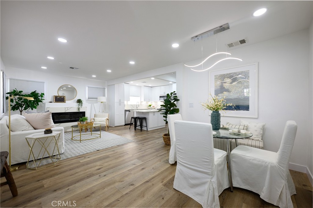 4705 East Washington Avenue Orange, CA 92869 - Photo 4 of 41 a living room with furniture a fireplace and wooden floor