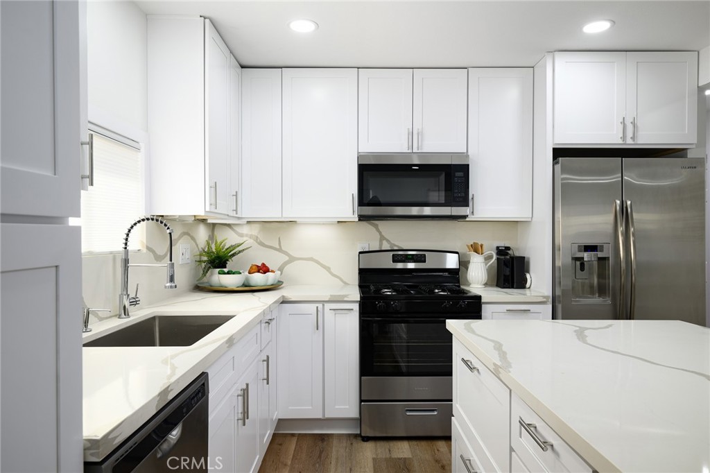 4705 East Washington Avenue Orange, CA 92869 - Photo 10 of 41 a kitchen with a sink a stove and refrigerator