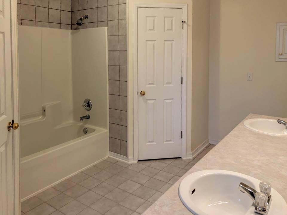 5196 Whitehurst Lane Crestview, FL 32536 - Photo 11 of 13 a bathroom with a sink and a tub