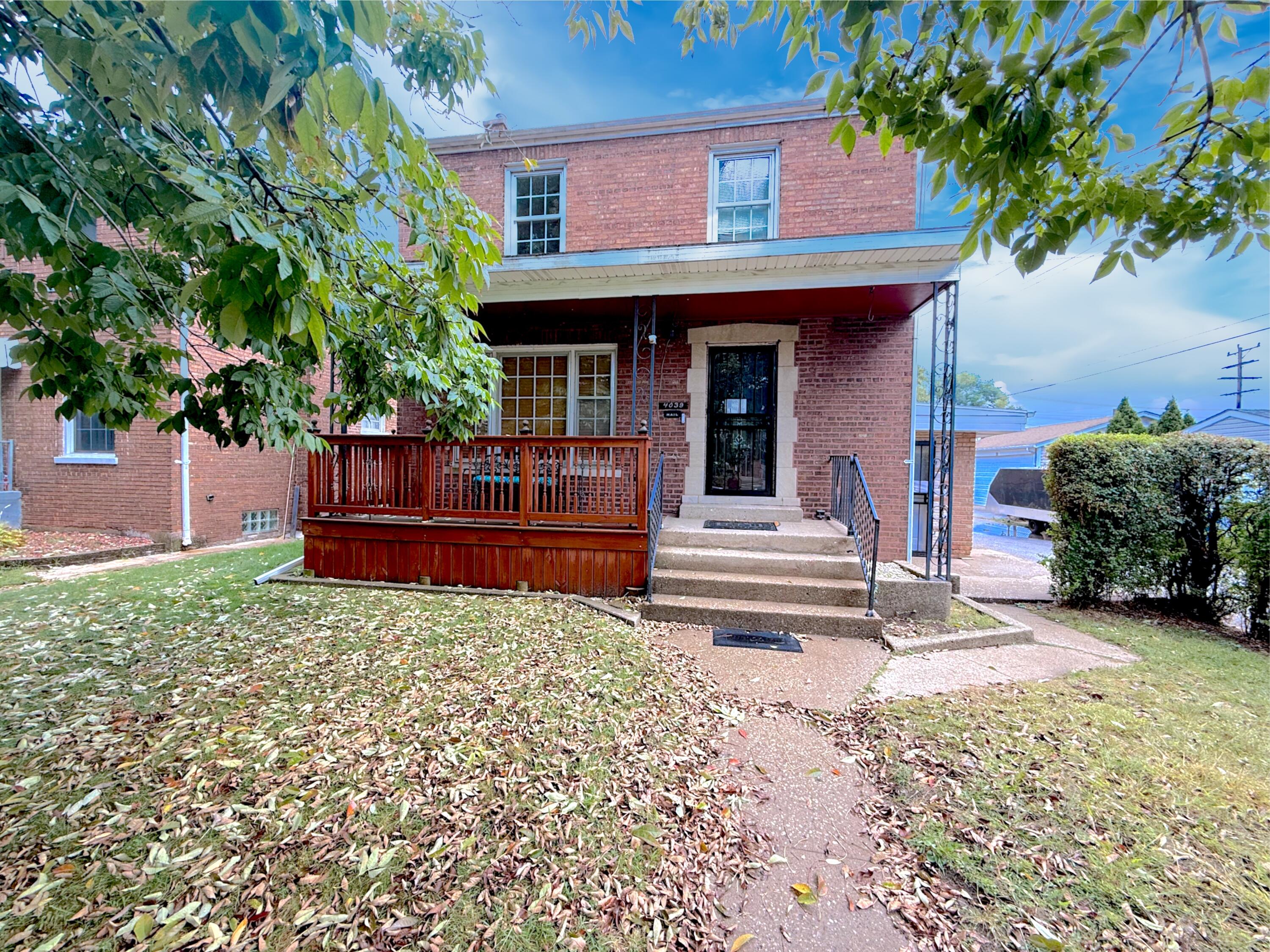 4039 Torrence Avenue Hammond, IN 46327 - Photo 2 of 34 a view of a house with a small yard and a large tree
