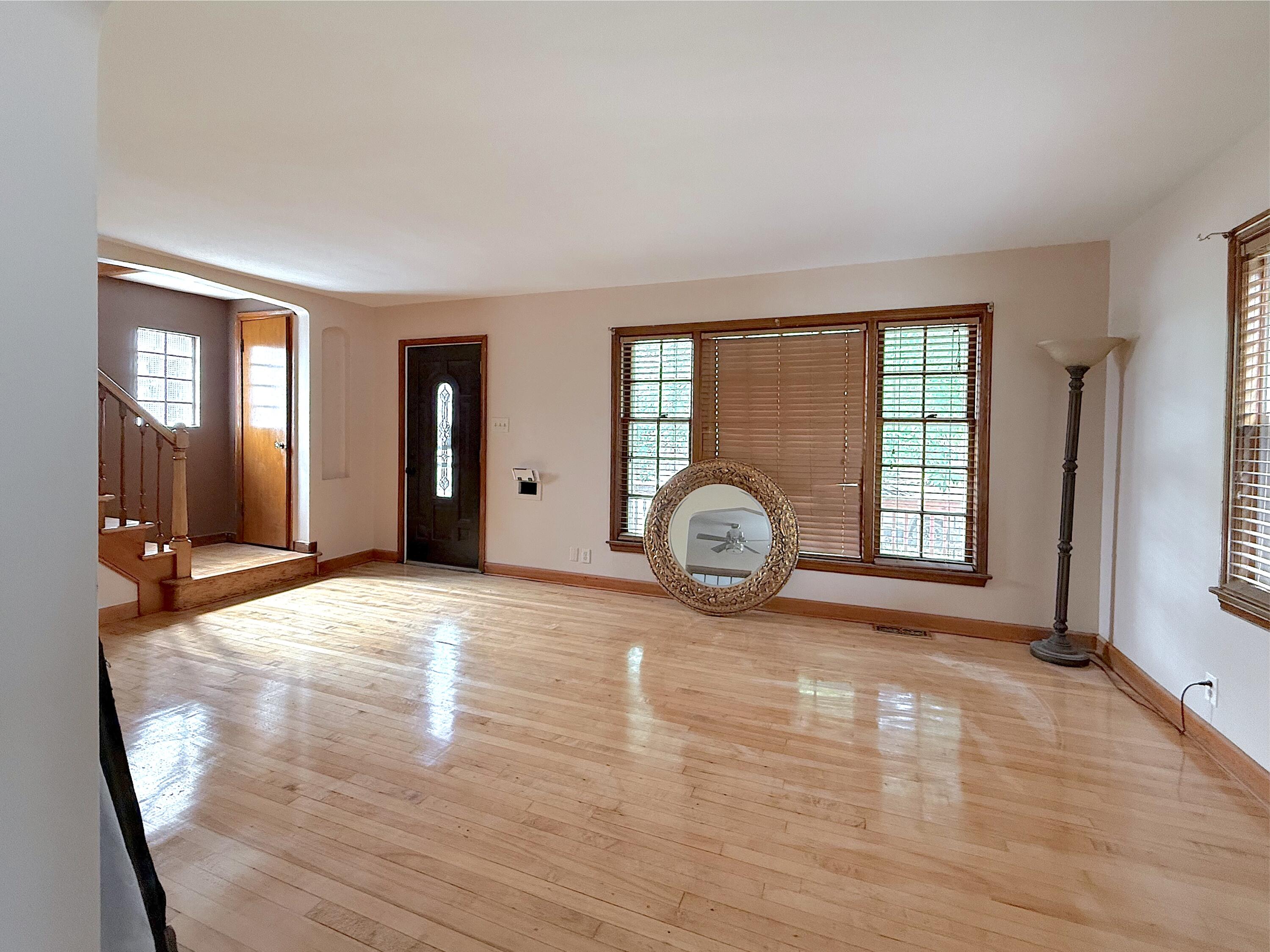 4039 Torrence Avenue Hammond, IN 46327 - Photo 6 of 34 an empty room with wooden floor and windows