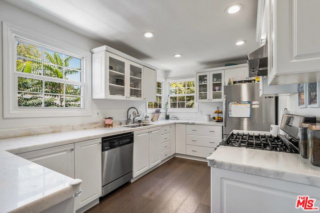 a kitchen with stove and cabinets