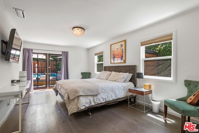 a bedroom with a large bed and a window