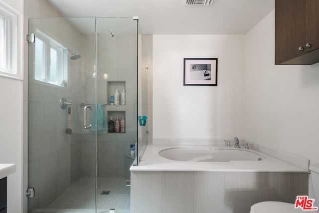 a en suite bathroom with a double vanity sink a mirror and a shower