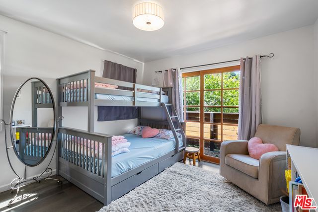 a view of a hallway with a livingroom and a dinning area with furniture