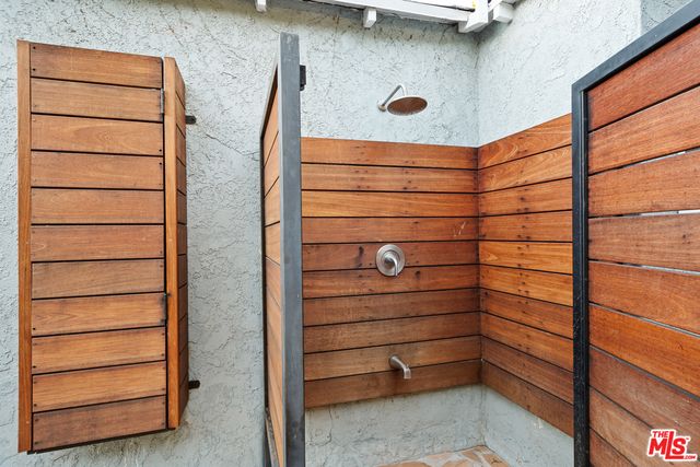 a patio with a table and chairs under an umbrella