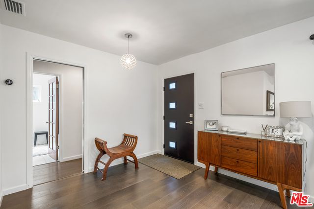 a living room with furniture flat screen tv and wooden floor