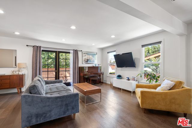 a living room with fireplace furniture and a flat screen tv