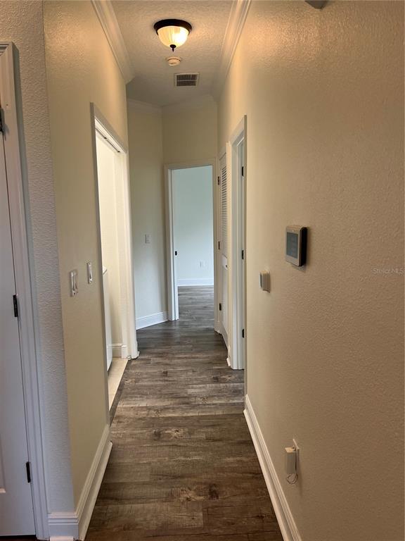 200 Riverview Bend South, Unit 921 Palm Coast, FL 32137 - Photo 12 of 27 a view of a hallway with wooden floor and a bathroom