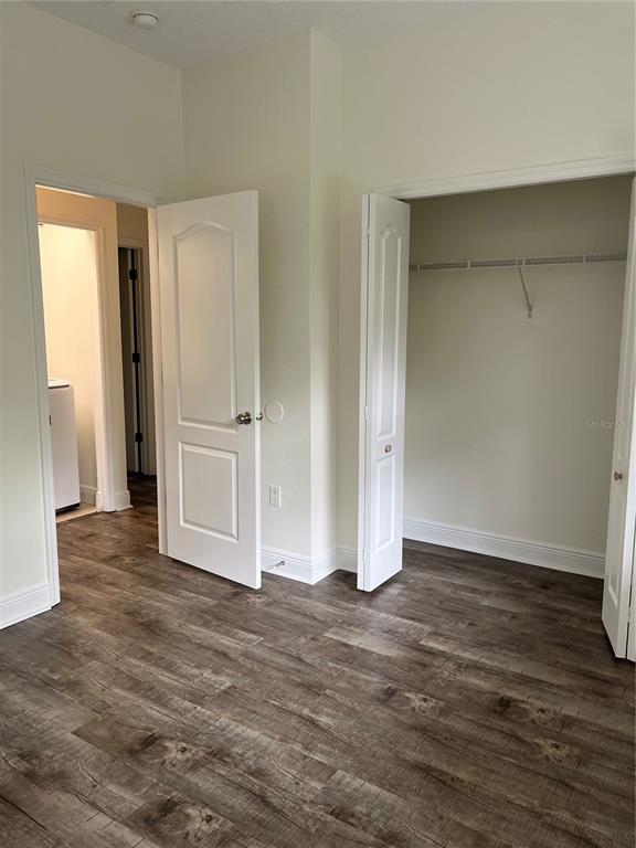 200 Riverview Bend South, Unit 921 Palm Coast, FL 32137 - Photo 20 of 27 an empty room with wooden floor and wooden door