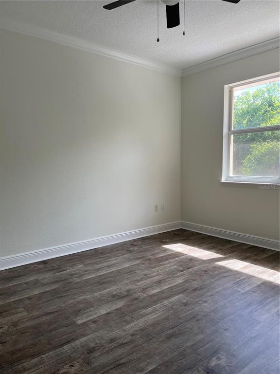 200 Riverview Bend South, Unit 921 Palm Coast, FL 32137 - Photo 23 of 27 an empty room with wooden floor and windows