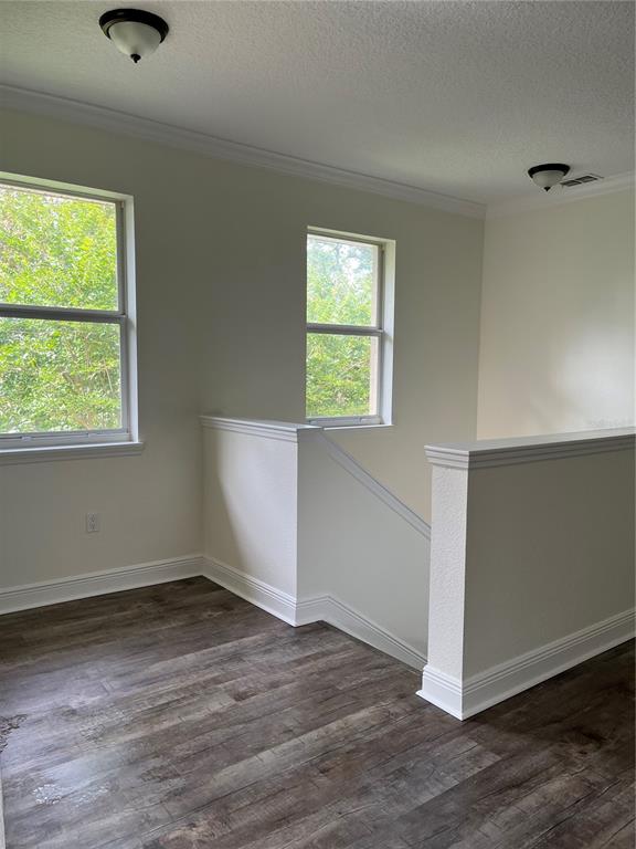 200 Riverview Bend South, Unit 921 Palm Coast, FL 32137 - Photo 7 of 27 an empty room with wooden floor and windows