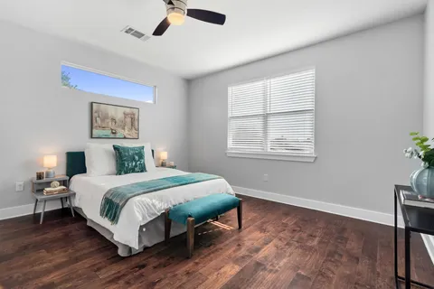 a bedroom with a bed lamp and window