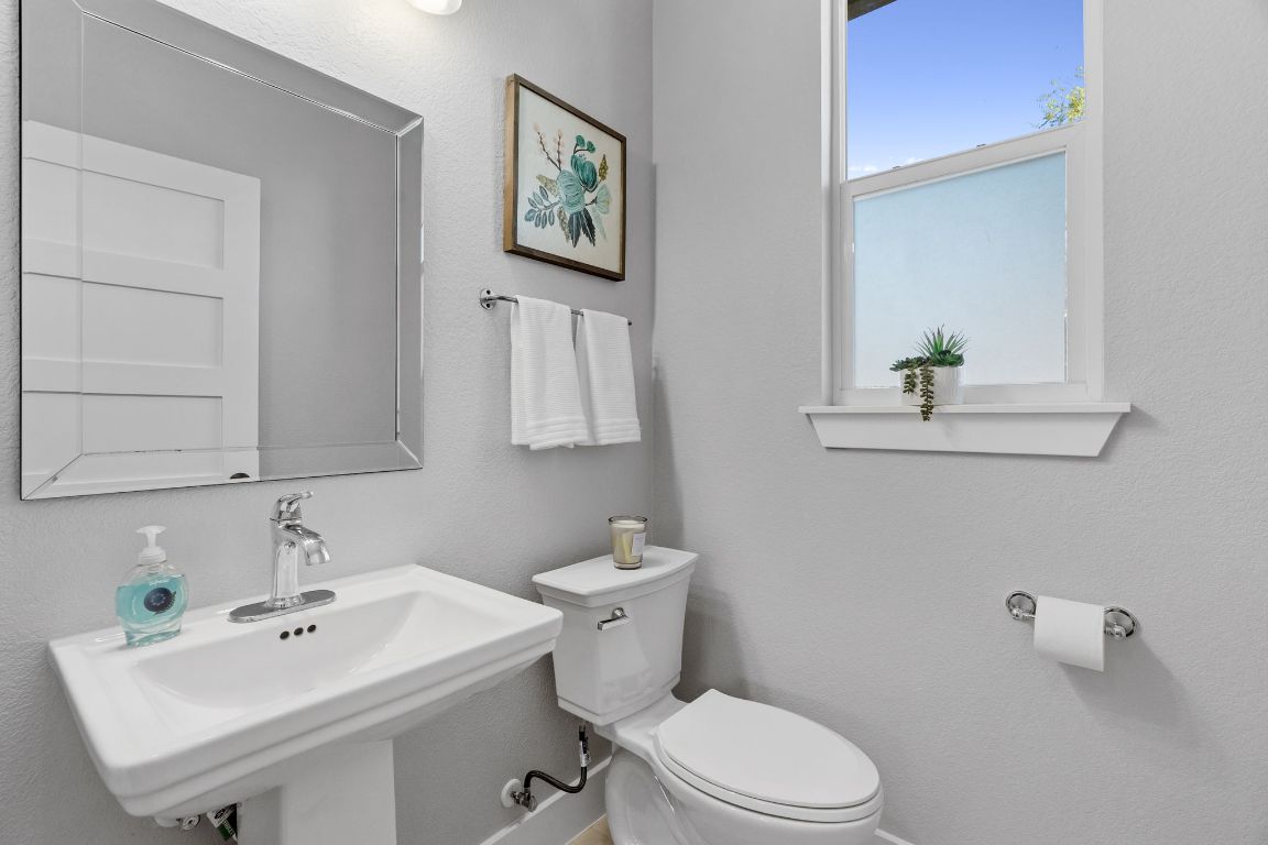 304 Blackson Avenue, Unit A Austin, TX 78752 - Photo 14 of 26 a bathroom with a sink mirror and toilet