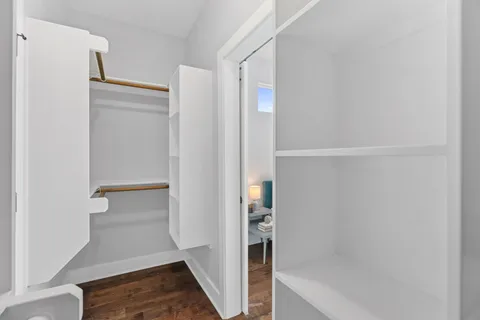 a view of walk in closet with empty racks