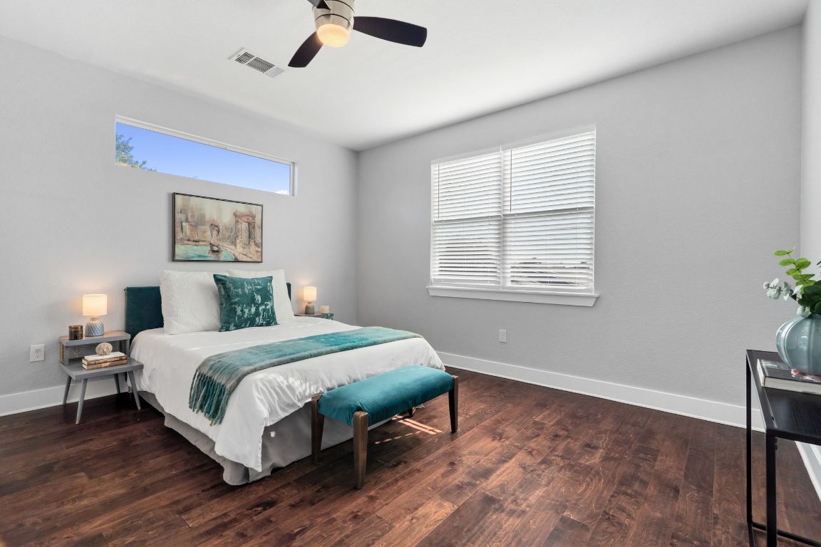 304 Blackson Avenue, Unit A Austin, TX 78752 - Photo 17 of 26 a bedroom with a bed lamp and window