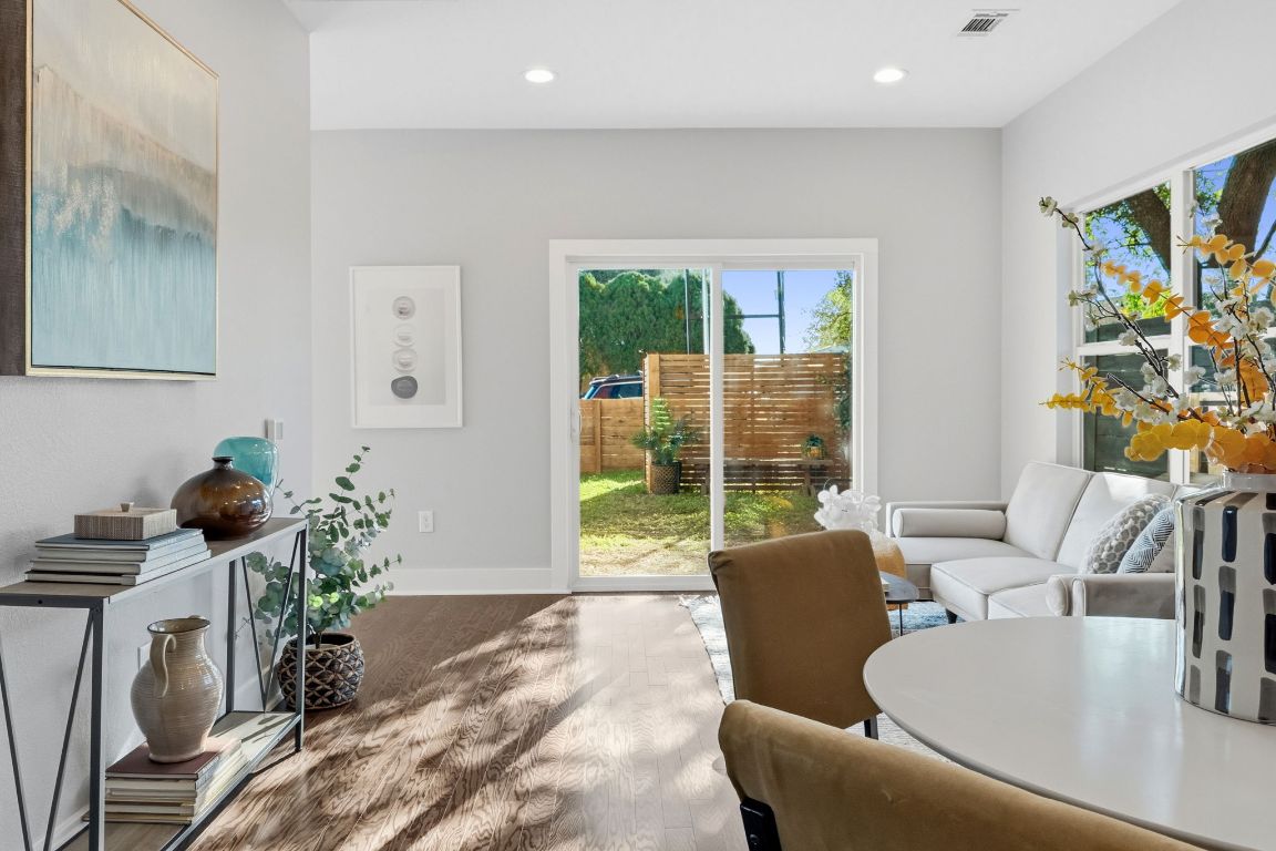304 Blackson Avenue, Unit A Austin, TX 78752 - Photo 9 of 26 a living room with furniture and a floor to ceiling window