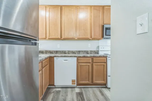 a view of a kitchen with granite countertop cabinets and a wooden floor
