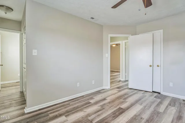 a view of a livingroom with wooden floor and closet