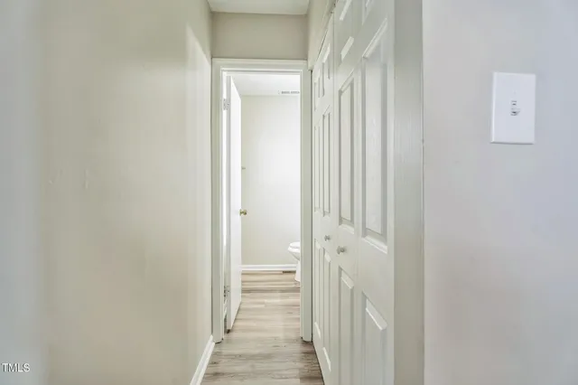a view of a bathroom from a hallway