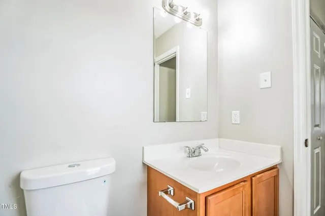 a bathroom with a sink a toilet and mirror
