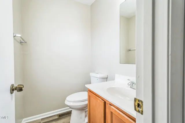 a bathroom with a sink toilet and vanity