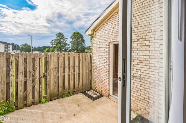 a picture of a bench in front of a wall